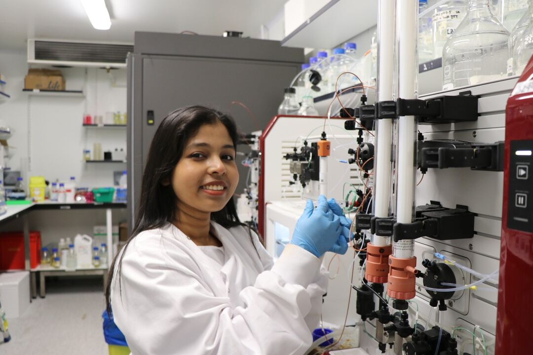 Student wearing a lab coat working in a laboratory 