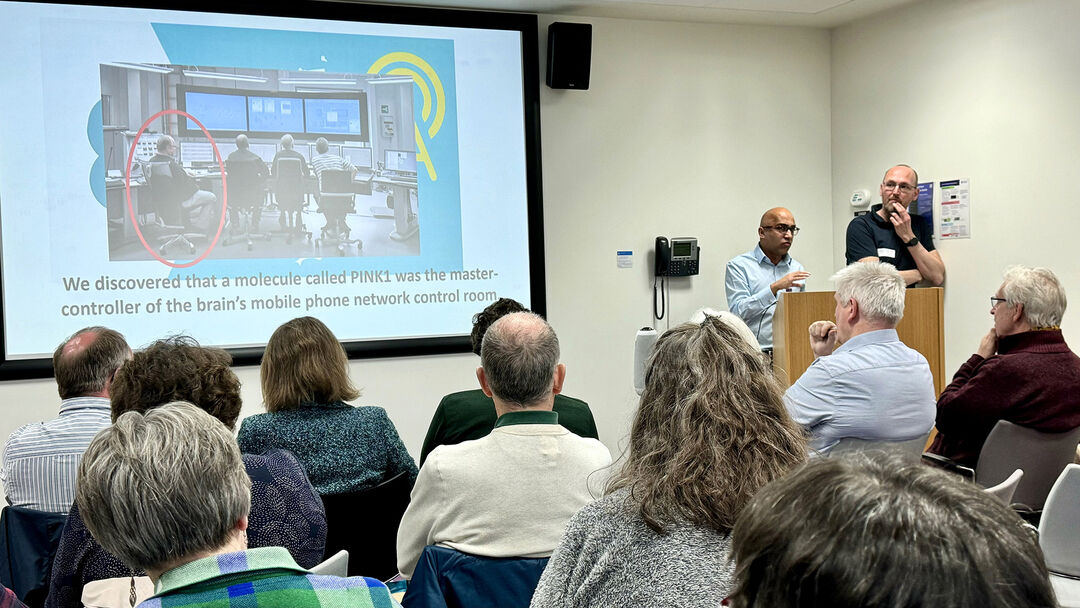 Two people giving a presentation to a group of people