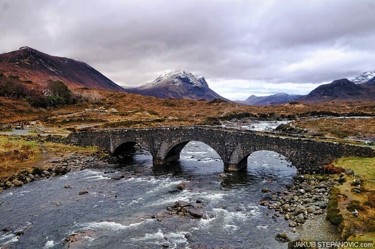 old arched bridge crossing stream