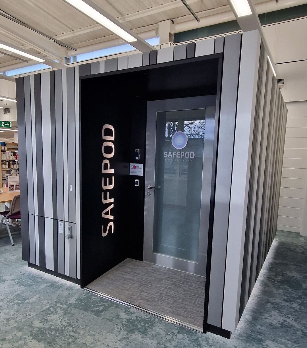 A Safepod in the library - a grey large box with a door.
