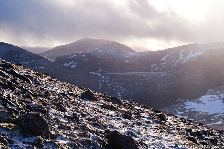 snowy rocky side of mountain