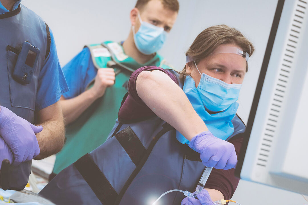 Iris Grunwald pulling a syringe while watching a screen