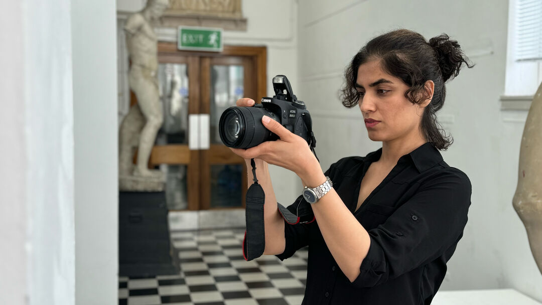 Mary Mousavi holding a camera