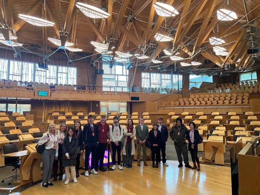 A group of students stand in the Scottish Parliament