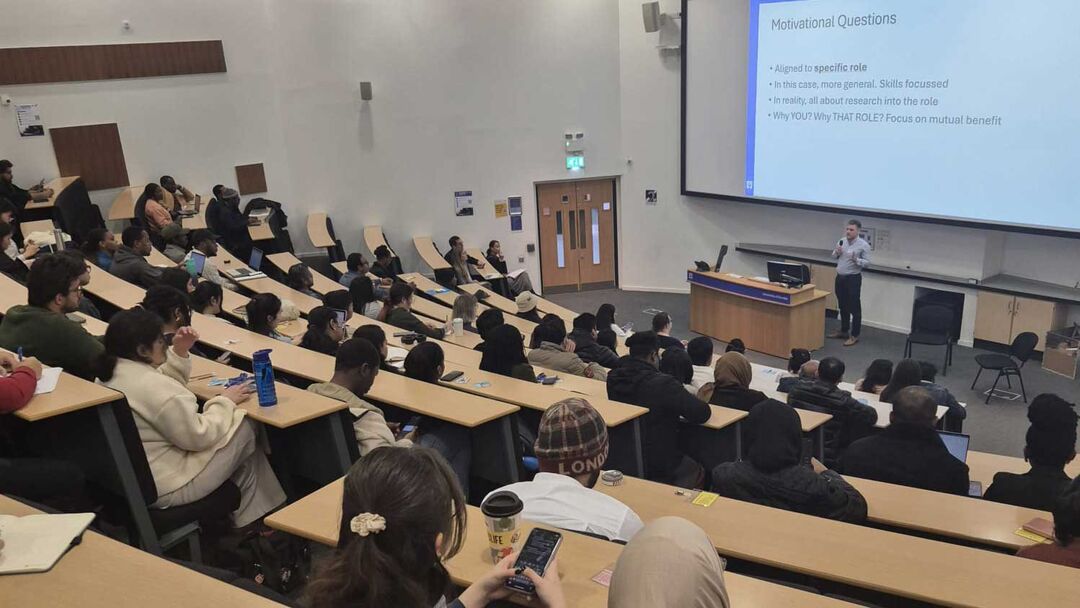 A group of students in a lecture theatre attending the International Student Symposium 