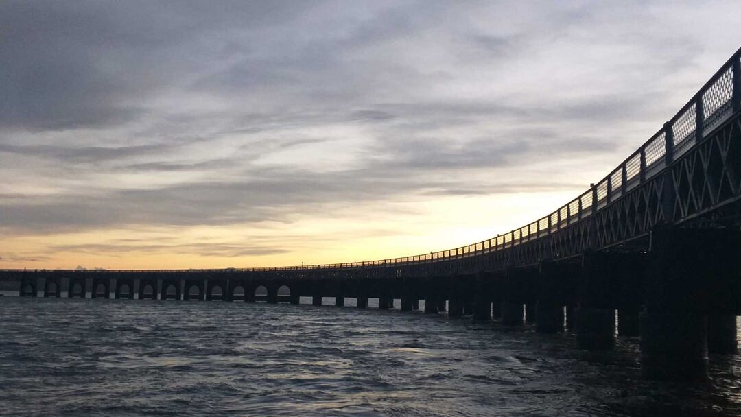 Picture of the River Tay and the Tay rail bridge during sunset.
