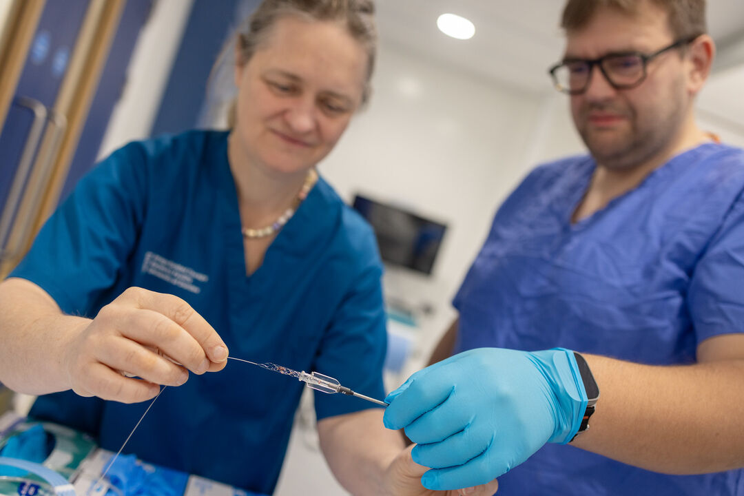 close up shot of two medical workers holding a piece of medical equipment 