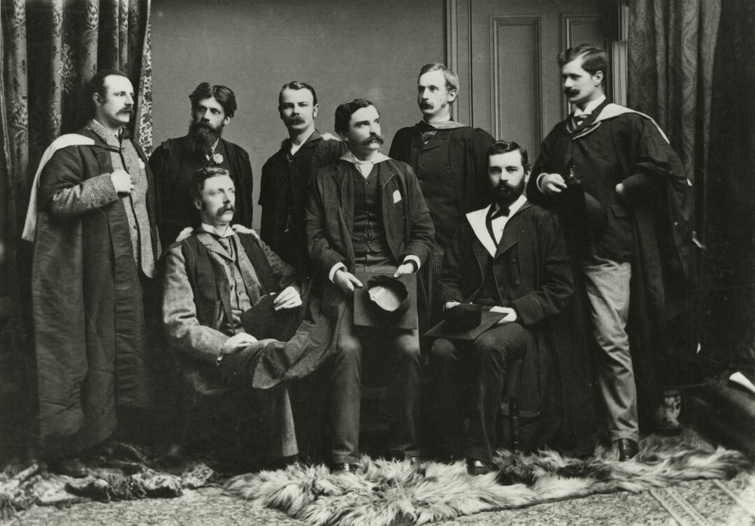 Black and white photo of Victoria era gentlemen, standing