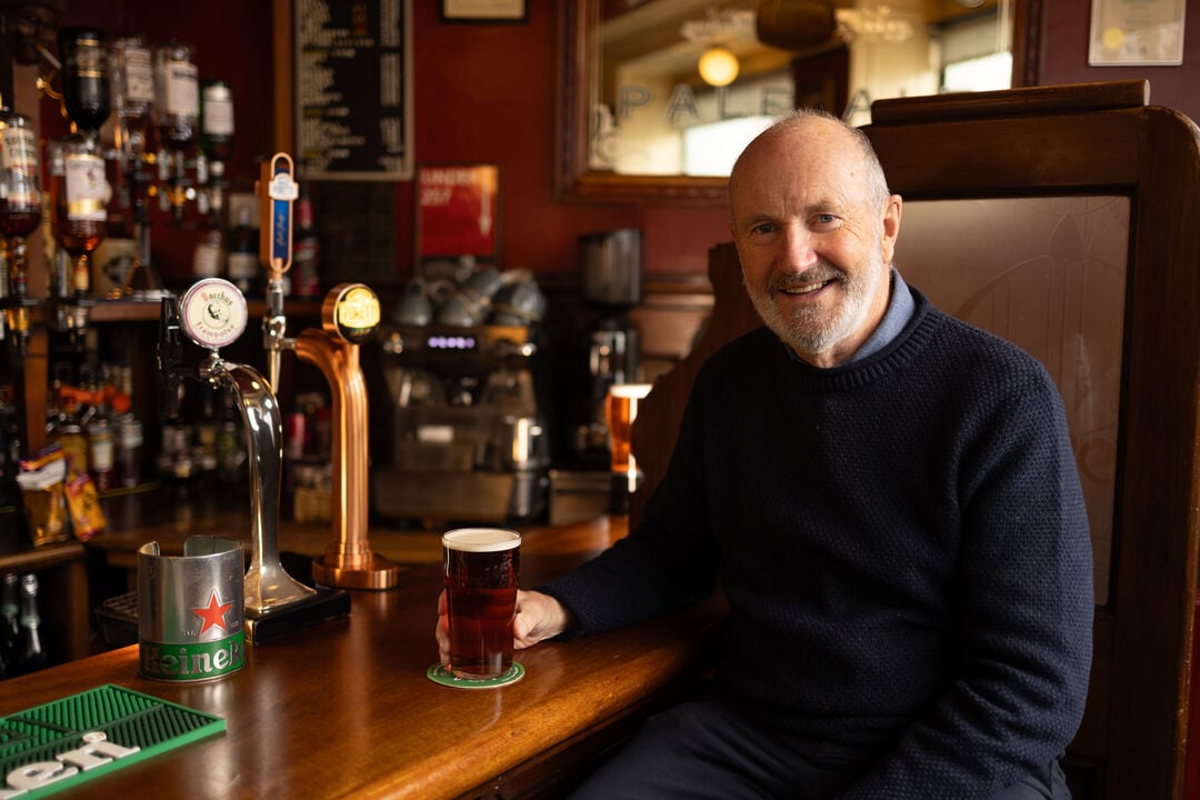 Fred MacAulay sits at the bar of the Speedwell Bar - better-known as Mennies - with a pint of beer
