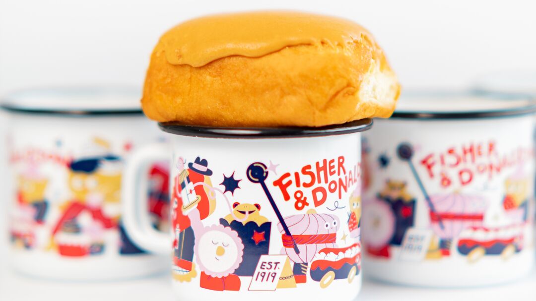 tin cups with cartoon cake characters and a real donut on top of one of the cups