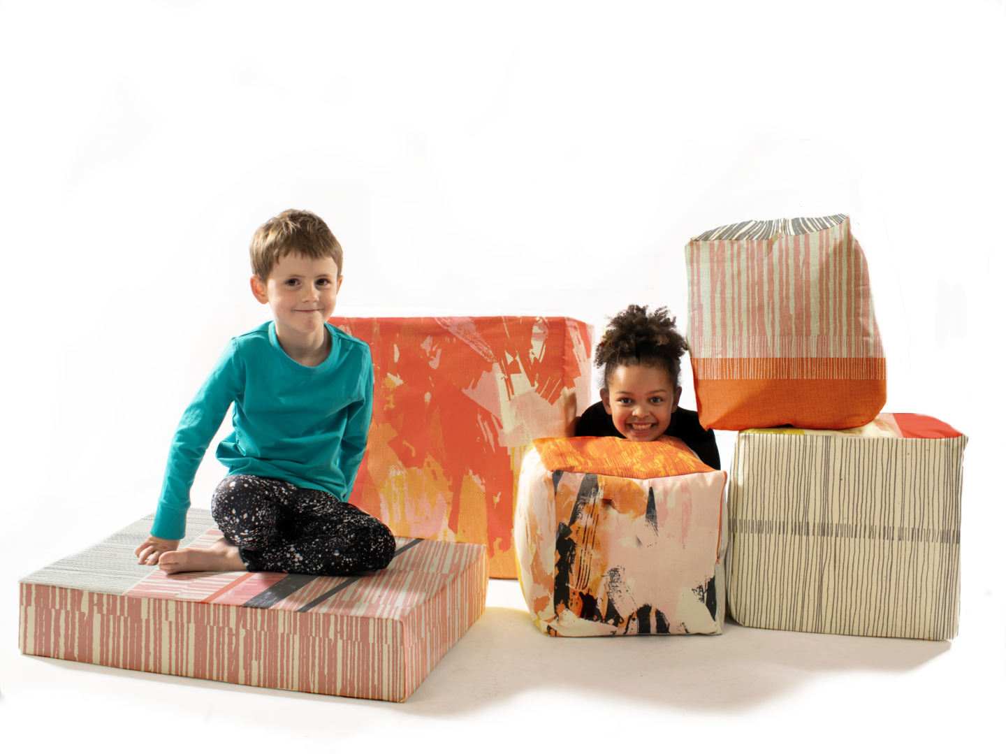 Two children play with the textile cubes.