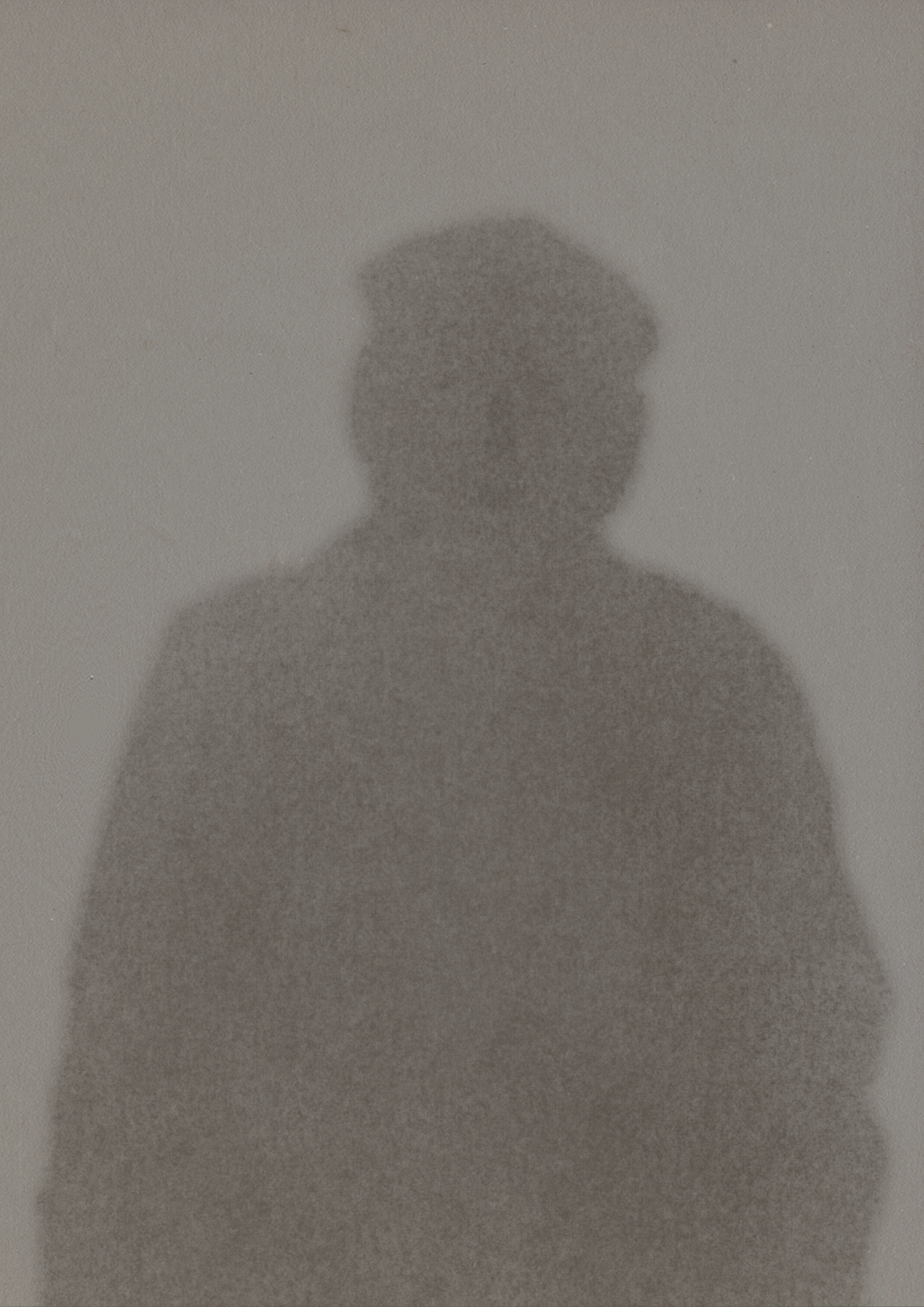 A blurry shadow/outline of somebody, they appear to be an older man. There is a face present within the mans outline but not quite enough to focus on. (Digital - pencil texture)